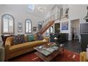 Stylish living room with high ceilings, staircase, modern decor, and natural light at 221 Ashley Ave # Abc, Charleston, SC 29403