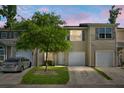 Charming townhome featuring a single-car garage and a well-manicured front lawn with a tree at 250 Grand Oaks Dr, Ladson, SC 29456