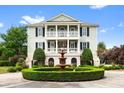 Attractive two-story home featuring a beautiful fountain surrounded by manicured landscaping at 2636 Anchor Watch Dr, Wadmalaw Island, SC 29487