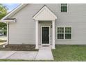 The exterior features a covered entrance and clean lines, showcasing the light gray siding and well-maintained grounds at 281 Jackson St, Goose Creek, SC 29445