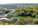 Scenic aerial shot of waterfront home with private dock, marsh views, and mature trees at 3104 Upda Creek, Seabrook Island, SC 29455
