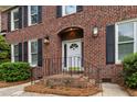 Inviting front entrance with brick steps, decorative railing, and charming exterior lighting at 312 E Shepard Ln, Summerville, SC 29483