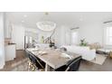 Bright, open dining room with a modern chandelier and stylish decor, connecting the kitchen and living area at 314 Archar St, Summerville, SC 29486