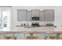 Modern kitchen with granite countertops, stainless steel appliances, and ample cabinet space at 314 Archar St, Summerville, SC 29486