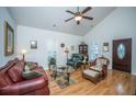 Bright living room featuring hardwood floors, vaulted ceilings, and comfortable seating arrangements at 320 Foxglove Ave, Summerville, SC 29483