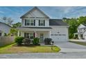Inviting two-story home with a classic design, lush landscaping, and a welcoming front porch in a suburban setting at 3208 Pecan Orchard Way, Charleston, SC 29414