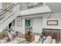 Bright foyer with stairs and hardwood floors leads to an open floorplan and a double-door entrance at 330 Concord St # 18F, Charleston, SC 29401