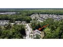Aerial view showcases property nestled among trees in a neighborhood at 3997 Aspera Dr, Summerville, SC 29483