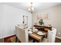 Dining room showcasing table setting, chandelier lighting, and rustic wood buffet at 413 Ribiero Dr, Summerville, SC 29486