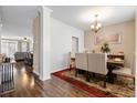 Elegant dining room with a wood table, upholstered chairs, and view into the living room at 413 Ribiero Dr, Summerville, SC 29486