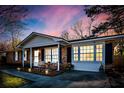 Inviting front porch of a brick home with cozy seating and decorative plants at 4437 Garwood Dr, Ladson, SC 29456
