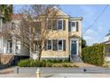 Inviting home with a manicured lawn, classic architectural style, and tasteful landscaping at 49 Ashley Ave, Charleston, SC 29401
