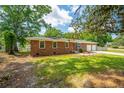 Brick house showcasing the side and front, complemented by green lawn at 5823 Lakeview Dr, Hanahan, SC 29410