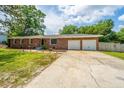 Traditional brick home featuring a two-car garage and a concrete driveway at 5823 Lakeview Dr, Hanahan, SC 29410