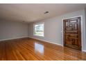 Bright living room with hardwood floors and a decorative front door at 5823 Lakeview Dr, Hanahan, SC 29410