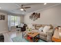 Inviting living room with modern furnishings, a ceiling fan, and large window at 6279 Lucille Dr # B, North Charleston, SC 29406