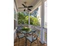 Inviting outdoor dining area on the covered porch with a glass table and comfortable seating at 700 Preservation Pl, Mount Pleasant, SC 29464