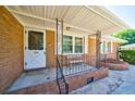 Welcoming front porch featuring brick accents, a white door with glass, and a small bench at 779 Dills Bluff Rd, Charleston, SC 29412