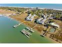 Aerial view showcases the coastal homes, waterways, and marshland landscape at 81 Sandbar Ln # 19, Folly Beach, SC 29439