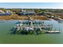 Aerial view of a waterfront community featuring boat lifts and docks on the marsh at 81 Sandbar Ln # 19, Folly Beach, SC 29439