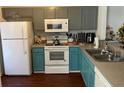 Functional kitchen with painted cabinets, modern appliances and hardwood floors at 9010 Maple Grove Dr, Summerville, SC 29485