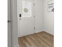 Bright entryway featuring wood-look flooring and a stylish front door at 9105 Parlor Dr, Ladson, SC 29456