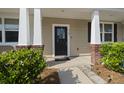 Inviting front porch with stylish columns and a welcoming entrance at 9105 Parlor Dr, Ladson, SC 29456