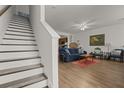Cozy living room with staircase, wood floors, and ample natural light at 9105 Parlor Dr, Ladson, SC 29456