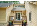 Charming front porch with a welcoming wreath and decorative plants at 10 Skyeman Dr, Charleston, SC 29414