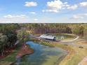 Breathtaking aerial view of a community pond with a wooden bridge and surrounding landscape at 1013 Sagegrass St, Summerville, SC 29485
