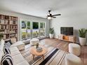 Bright living room featuring large windows, hardwood floors, and modern furnishings, creating a cozy atmosphere at 102 Rebellion Rd, Summerville, SC 29483