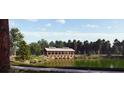 Scenic wooden pavilion over a tranquil lake surrounded by lush greenery and walking path at 1037 Tulip Shell St, Summerville, SC 29485