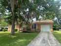 Inviting single-story brick home with lush landscaping and a spacious driveway, offering curb appeal at 104 Belmont Ct, Ladson, SC 29456