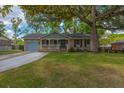 Charming single-story home with a welcoming front porch and a lush, well-manicured lawn at 104 Greensboro Ln, Ladson, SC 29456