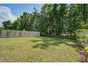 Large, grassy backyard enclosed by a white fence, offering privacy and space for recreation at 1059 Sago Palm Ct, Mount Pleasant, SC 29429