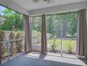 Relaxing screened-in porch with sheer curtains, offering a view of the private backyard at 1059 Sago Palm Ct, Mount Pleasant, SC 29429