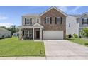 Charming two-story home with a brick facade, well-manicured lawn, and inviting front porch at 110 Levis Song Ct, Goose Creek, SC 29445