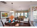Cozy dining area with hardwood floors, large windows, and stylish furnishings, adjacent to the living room at 113 Crosscut Ln, Summerville, SC 29486