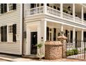 Close-up of the front door with a brick pillar, and beautiful architectural design at 12 Orange St, Charleston, SC 29401
