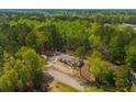An aerial shot showcasing a home nestled within a community surrounded by lush forests at 120 Perry Hill Rd, Moncks Corner, SC 29461