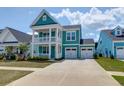 Charming two-story home boasts a welcoming double porch and attached two-car garage at 1238 Homecoming Blvd Blvd, Ravenel, SC 29470