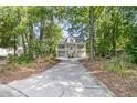 Beautiful home nestled in a wooded lot with a long drive leading up to the double porch at 1325 Moss Path, Mount Pleasant, SC 29464