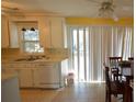 Bright kitchen with white cabinets, stainless steel sink, and sliding glass door for easy outdoor access at 1340 Ashley Hall Rd, Charleston, SC 29407