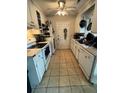 Functional kitchen featuring white appliances, ample cabinet space, and tile flooring for easy cleanup at 1340 Ashley Hall Rd, Charleston, SC 29407