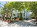 Inviting two-story home with a covered front porch and beautifully landscaped yard at 15 Rutledge Ave, Charleston, SC 29401