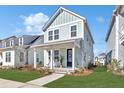 Charming two-story home featuring a welcoming front porch and professionally landscaped yard at 150 Midtown Ave, Summerville, SC 29486