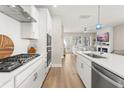 Modern kitchen featuring white cabinets, stainless steel appliances, and an island with seating at 150 Midtown Ave, Summerville, SC 29486