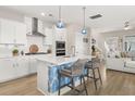 Modern kitchen featuring white cabinets, stainless steel appliances, and island with seating at 150 Midtown Ave, Summerville, SC 29486