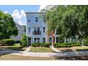 View of townhomes with manicured landscaping and a sidewalk leading to the entryways at 1589 Bluewater Way, Charleston, SC 29414