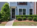 A charming entryway features lush greenery and a welcoming door with a wreath at 1589 Bluewater Way, Charleston, SC 29414
